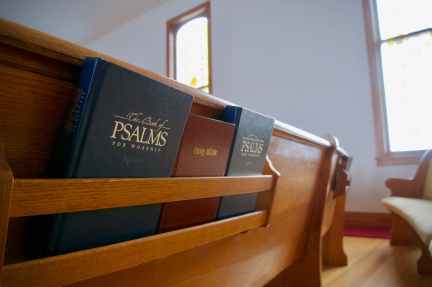 three bibles on wooden bench