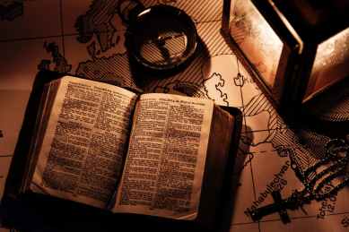 opened bible on wooden surfaca