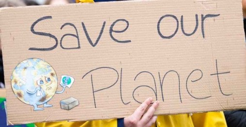 person holding save our planet sign