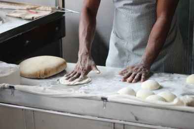 man preparing dough for bread